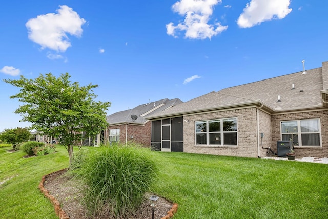 1420 Whispering Oaks Dr, Lebanon, TN 37090 - rear view of house with brick siding, a yard, roof with shingles, and central AC unit