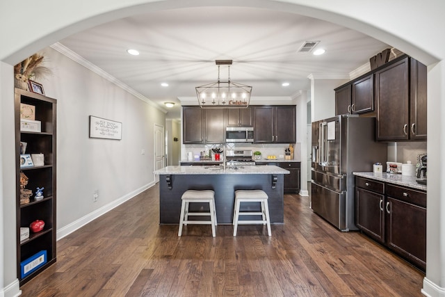 1420 Whispering Oaks Dr, Lebanon, TN 37090 - kitchen with appliances with stainless steel finishes, ornamental molding, dark brown cabinetry, a kitchen breakfast bar, and tasteful backsplash