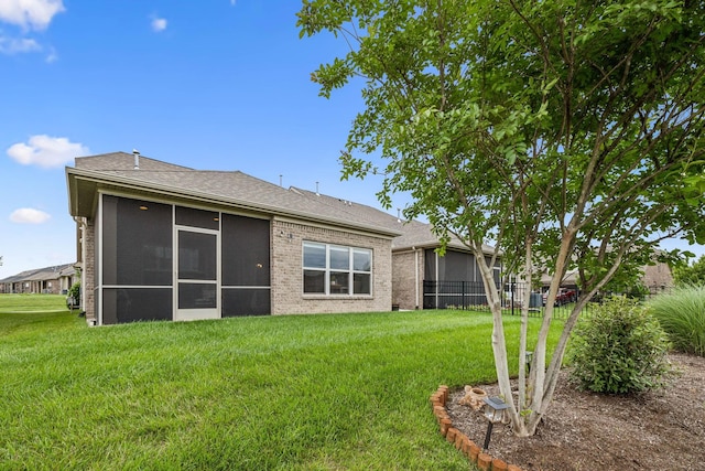 1420 Whispering Oaks Dr, Lebanon, TN 37090 - back of house featuring a sunroom, brick siding, and roof with shingles