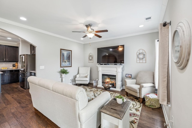1420 Whispering Oaks Dr, Lebanon, TN 37090 - living area with dark wood-type flooring, a glass covered fireplace, ceiling fan, arched walkways, and recessed lighting