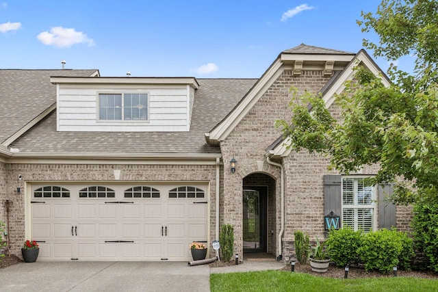 1420 Whispering Oaks Dr, Lebanon, TN 37090 - french country inspired facade featuring brick siding, driveway, a garage, and a shingled roof