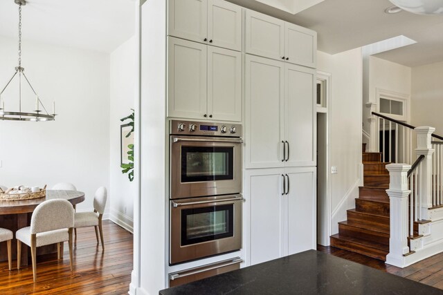 1051 W Main St, Franklin, TN 37064 - kitchen featuring stainless steel double oven, dark wood finished floors, a warming drawer, and baseboards