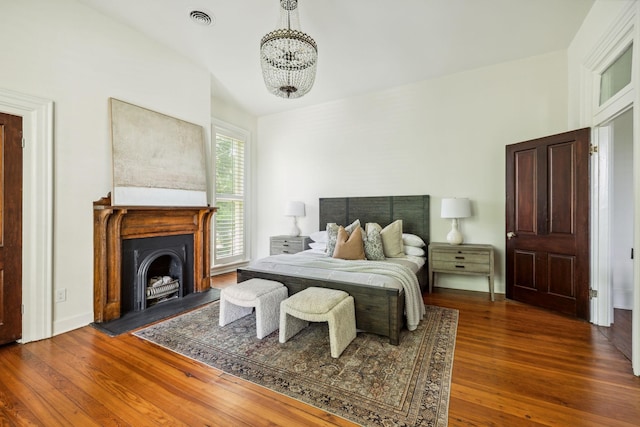 1051 W Main St, Franklin, TN 37064 - bedroom with a chandelier, wood finished floors, and a fireplace with flush hearth