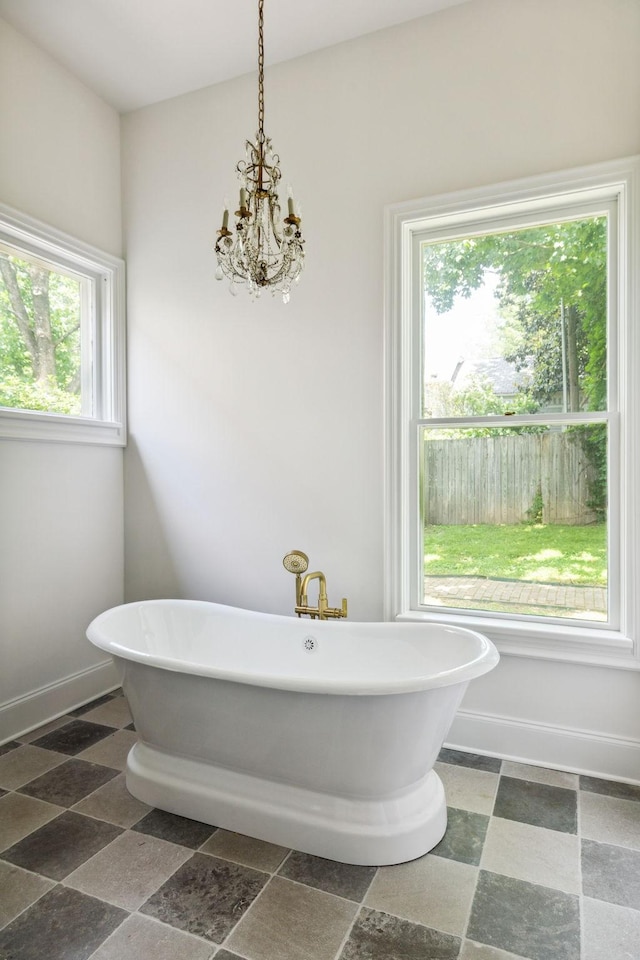 1051 W Main St, Franklin, TN 37064 - full bath with a freestanding tub, a chandelier, and baseboards