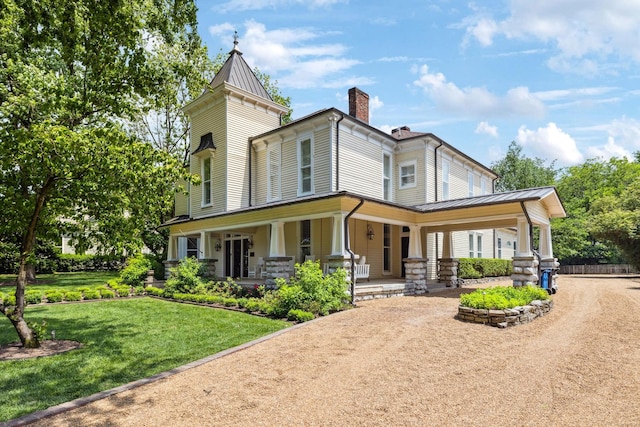 1051 W Main St, Franklin, TN 37064 - view of front of home with a standing seam roof, a porch, a chimney, metal roof, and a front yard