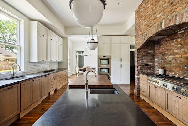 1051 W Main St, Franklin, TN 37064 - kitchen featuring a sink, appliances with stainless steel finishes, dark wood-style flooring, and tasteful backsplash