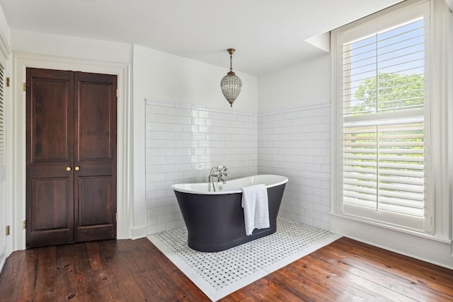 1051 W Main St, Franklin, TN 37064 - full bathroom featuring hardwood / wood-style flooring, a freestanding tub, and tile walls