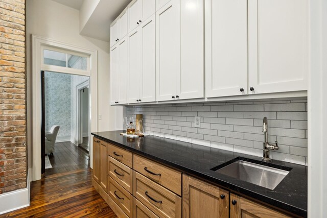 1051 W Main St, Franklin, TN 37064 - kitchen featuring a sink, dark wood finished floors, dark stone counters, tasteful backsplash, and white cabinets