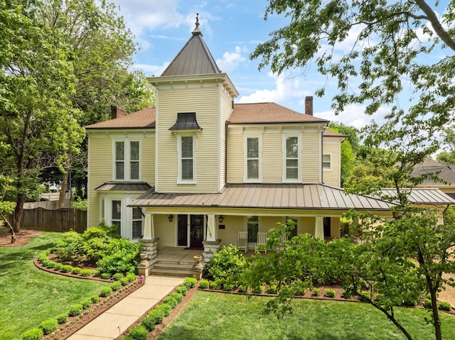 1051 W Main St, Franklin, TN 37064 - victorian home with a standing seam roof, a chimney, metal roof, and a porch