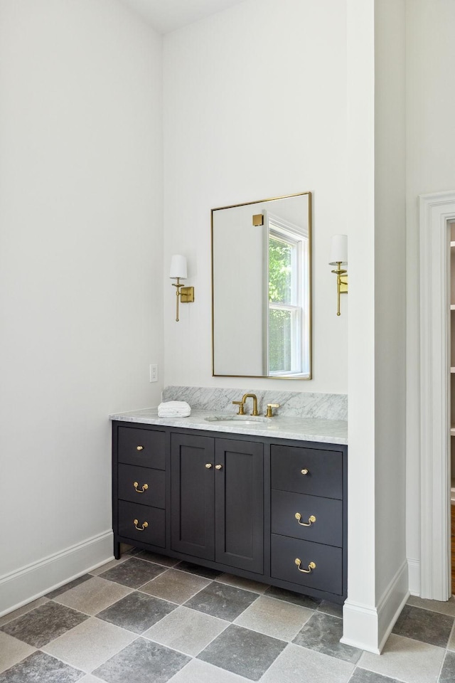 1051 W Main St, Franklin, TN 37064 - bathroom with vanity, stone finish floors, baseboards, and a towering ceiling