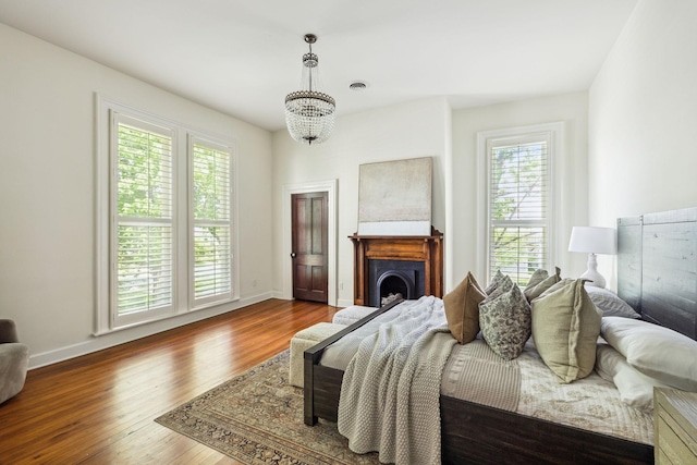 1051 W Main St, Franklin, TN 37064 - bedroom with wood finished floors, a chandelier, baseboards, and a fireplace