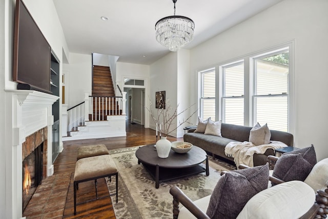 1051 W Main St, Franklin, TN 37064 - living area with stairs, a chandelier, a warm lit fireplace, and dark wood-type flooring