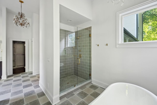 1051 W Main St, Franklin, TN 37064 - full bath with a chandelier, a soaking tub, baseboards, and a shower stall