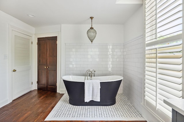 1051 W Main St, Franklin, TN 37064 - full bathroom with tile walls, wood finished floors, and a freestanding tub