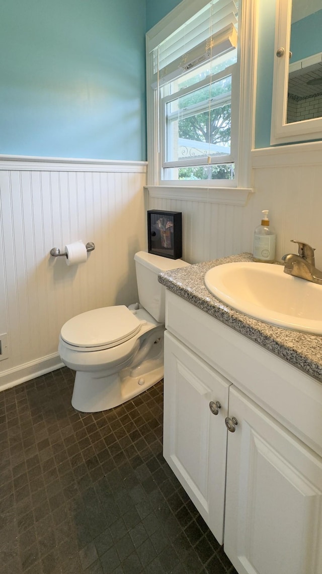 4011 Sheddan Dr, Columbia, TN 38401 - bathroom with toilet, a wainscoted wall, and vanity