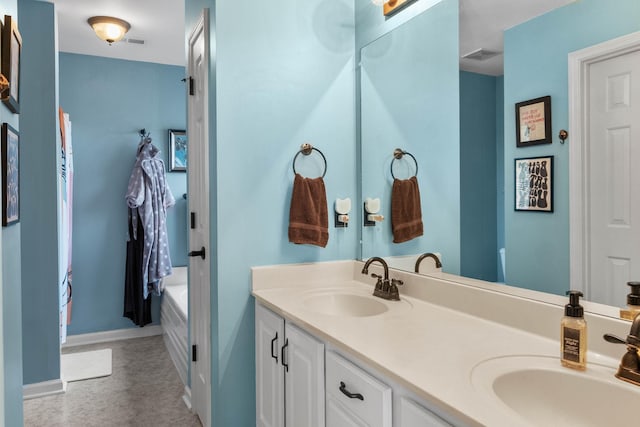 125 Wembly Ct, Franklin, TN 37067 - full bathroom with double vanity, baseboards, and a tub to relax in