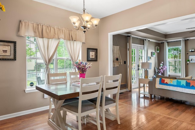 125 Wembly Ct, Franklin, TN 37067 - dining area with healthy amount of natural light, a chandelier, ornamental molding, baseboards, and wood finished floors