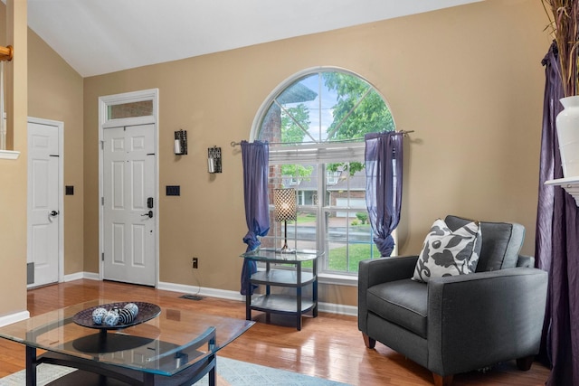 125 Wembly Ct, Franklin, TN 37067 - living room featuring wood finished floors, vaulted ceiling, and baseboards