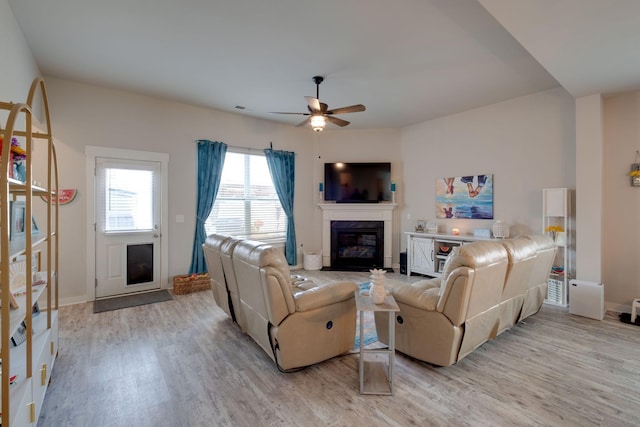 308 Whisper Wood Way, Lebanon, TN 37087 - living room featuring a premium fireplace, light wood-style floors, ceiling fan, and baseboards