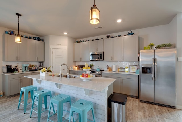 308 Whisper Wood Way, Lebanon, TN 37087 - kitchen featuring appliances with stainless steel finishes, light wood-style flooring, backsplash, pendant lighting, and recessed lighting
