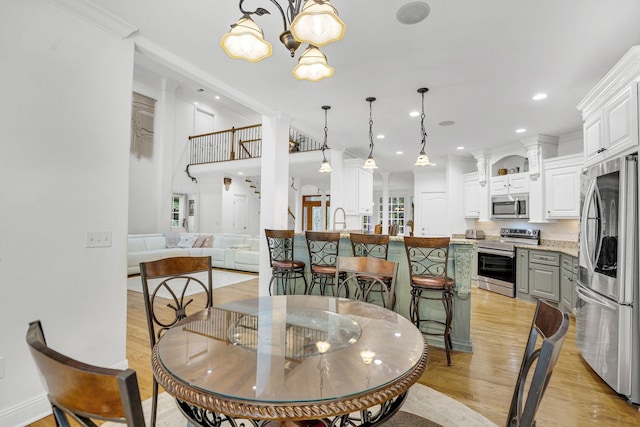 6948 Whispering Oaks Dr, Springfield, TN 37172 - dining area with light wood-style floors, a chandelier, and recessed lighting
