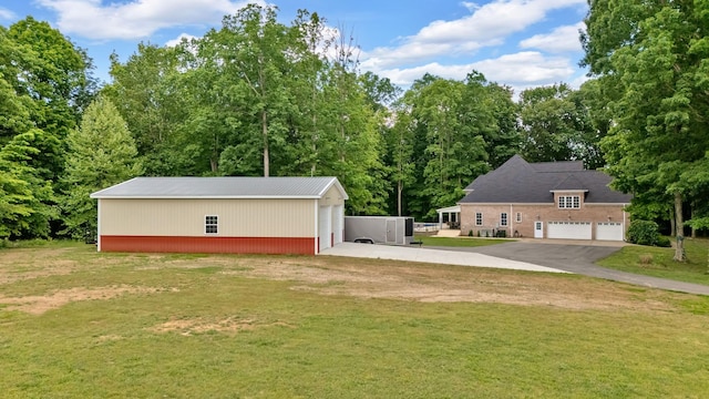 6948 Whispering Oaks Dr, Springfield, TN 37172 - view of grassy yard with a detached garage, an outbuilding, and driveway