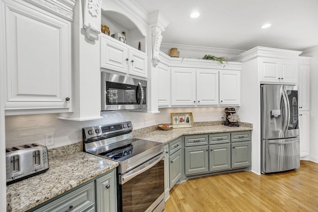 6948 Whispering Oaks Dr, Springfield, TN 37172 - kitchen with appliances with stainless steel finishes, gray cabinetry, white cabinetry, light wood finished floors, and recessed lighting