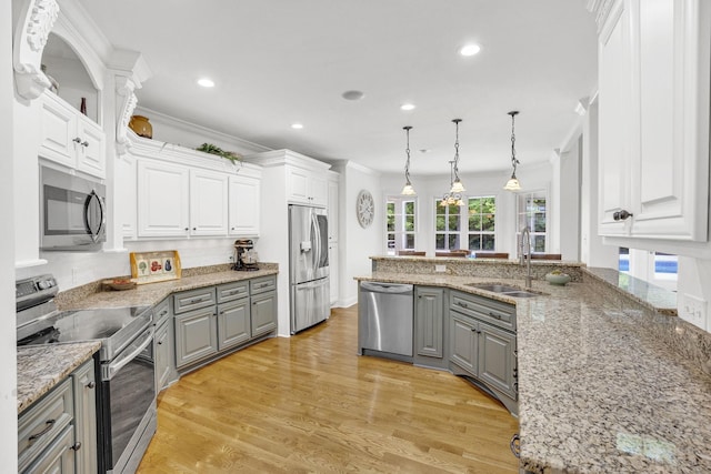 6948 Whispering Oaks Dr, Springfield, TN 37172 - kitchen featuring appliances with stainless steel finishes, gray cabinetry, a sink, white cabinetry, and ornamental molding