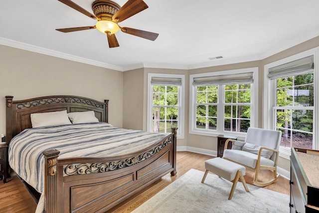 6948 Whispering Oaks Dr, Springfield, TN 37172 - bedroom with multiple windows, baseboards, ornamental molding, ceiling fan, and light wood-style flooring