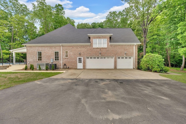 6948 Whispering Oaks Dr, Springfield, TN 37172 - view of front facade featuring driveway, brick siding, an attached garage, and cooling unit