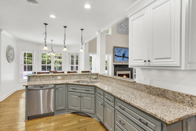 6948 Whispering Oaks Dr, Springfield, TN 37172 - kitchen with dishwasher, gray cabinets, a sink, a lit fireplace, and crown molding
