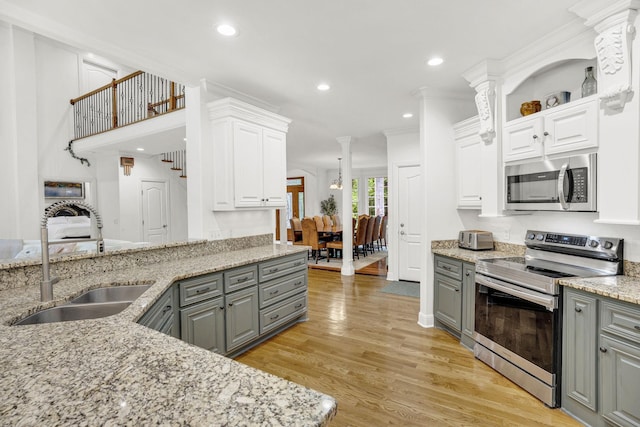 6948 Whispering Oaks Dr, Springfield, TN 37172 - kitchen featuring stainless steel appliances, gray cabinetry, a sink, decorative columns, and recessed lighting