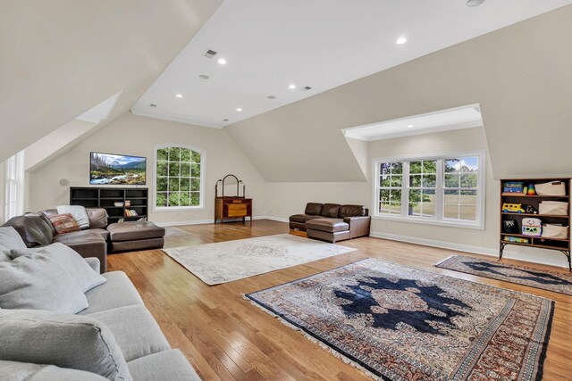 6948 Whispering Oaks Dr, Springfield, TN 37172 - living area featuring light wood-style flooring, plenty of natural light, vaulted ceiling, baseboards, and recessed lighting
