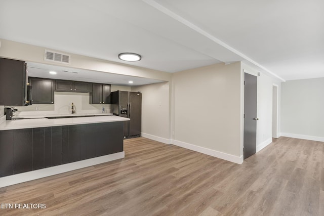 17 Westover Dr, Oak Ridge, TN 37830 - kitchen featuring black refrigerator with ice dispenser, light countertops, light wood finished floors, baseboards, and recessed lighting