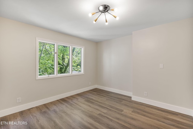 17 Westover Dr, Oak Ridge, TN 37830 - empty room with a chandelier, baseboards, and wood finished floors