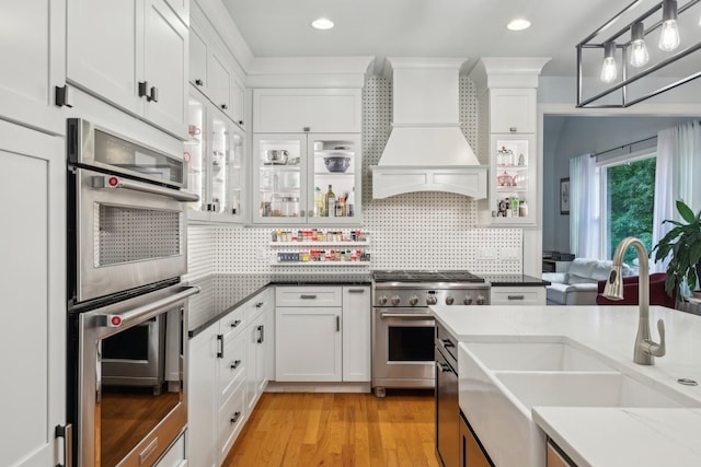 1313 Ridge Rd, Dickson, TN 37055 - kitchen featuring stainless steel appliances, a sink, custom exhaust hood, white cabinets, and recessed lighting