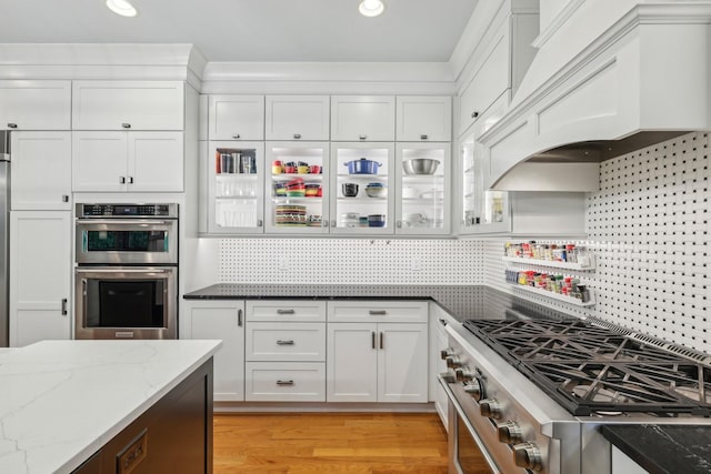 1313 Ridge Rd, Dickson, TN 37055 - kitchen with appliances with stainless steel finishes, custom exhaust hood, white cabinetry, backsplash, and recessed lighting