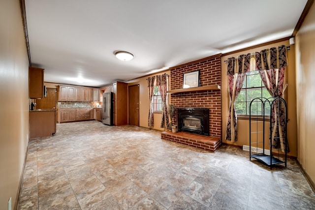 120 Donna Dr, Hendersonville, TN 37075 - unfurnished living room featuring healthy amount of natural light, stone finish flooring, and baseboards