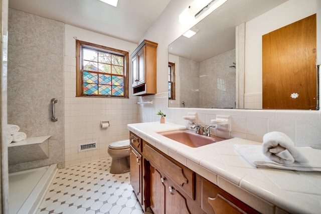 120 Donna Dr, Hendersonville, TN 37075 - bathroom featuring a stall shower, tile walls, toilet, and vanity