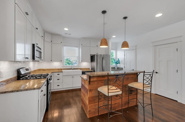 801 Lancaster Way, Nashville, TN 37212 - kitchen with stainless steel appliances, a sink, a center island, backsplash, and dark wood-type flooring