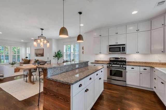 801 Lancaster Way, Nashville, TN 37212 - kitchen with appliances with stainless steel finishes, open floor plan, tasteful backsplash, dark wood-style floors, and a kitchen island