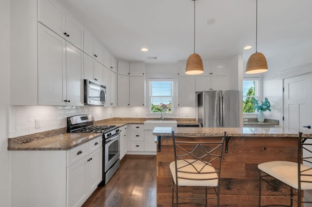 801 Lancaster Way, Nashville, TN 37212 - kitchen with stainless steel appliances, a kitchen bar, backsplash, white cabinets, and recessed lighting