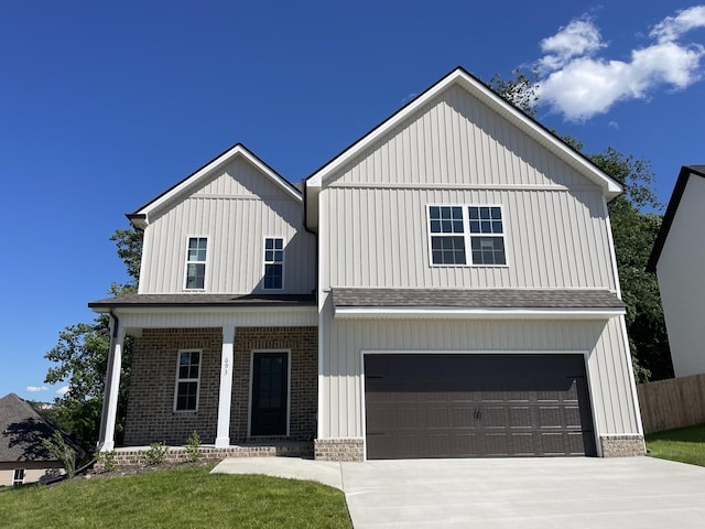693 Eva Agnes, Clarksville, TN 37042 - view of front of house featuring an attached garage, a porch, brick siding, and board and batten siding