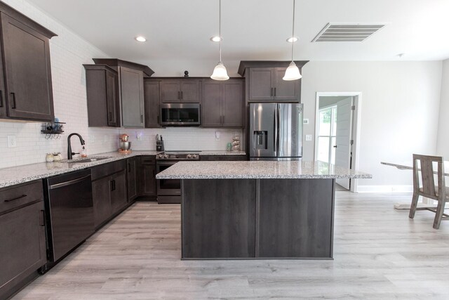 222 Preacher Roberson Rd, Castalian Springs, TN 37031 - kitchen with stainless steel appliances, a sink, dark brown cabinets, decorative backsplash, and recessed lighting