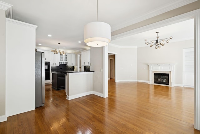 3008 Flagstone Dr, Franklin, TN 37069 - kitchen featuring a chandelier, freestanding refrigerator, wood finished floors, open floor plan, and tasteful backsplash