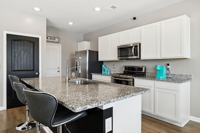 866 Long Leaf Rd, Lebanon, TN 37087 - kitchen with stainless steel appliances, dark wood finished floors, a sink, white cabinetry, and an island with sink