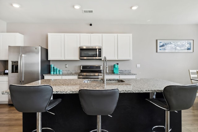 866 Long Leaf Rd, Lebanon, TN 37087 - kitchen featuring appliances with stainless steel finishes, a sink, wood finished floors, white cabinetry, and recessed lighting