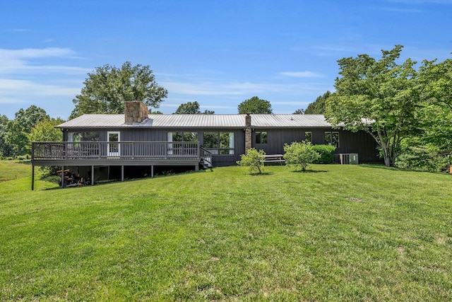2993 Hobbitshire Dr, Centerville, TN 37033 - rear view of property featuring a chimney, a lawn, a deck, and metal roof