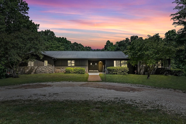 2993 Hobbitshire Dr, Centerville, TN 37033 - view of front of property featuring stone siding, metal roof, a yard, gravel driveway, and board and batten siding