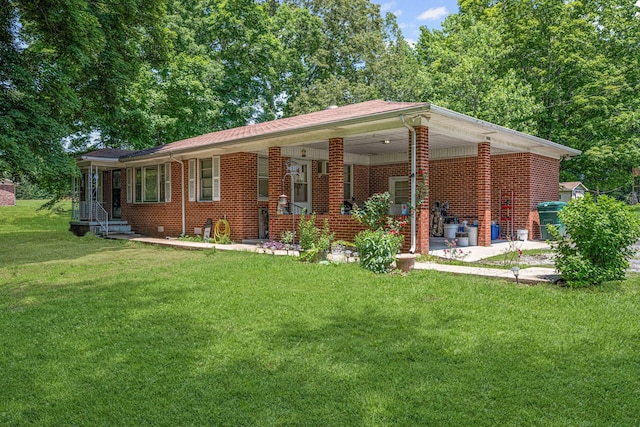 4409 Carter Dr, Nunnelly, TN 37137 - view of front of home featuring a front yard, brick siding, and an attached carport